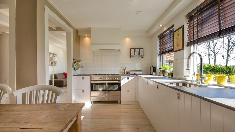 A spacious kitchen with brown corded blinds