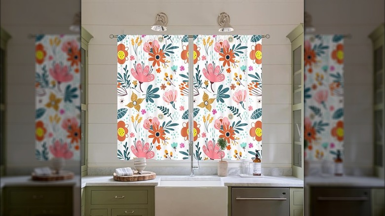 Floral patterned curtains above a kitchen sink