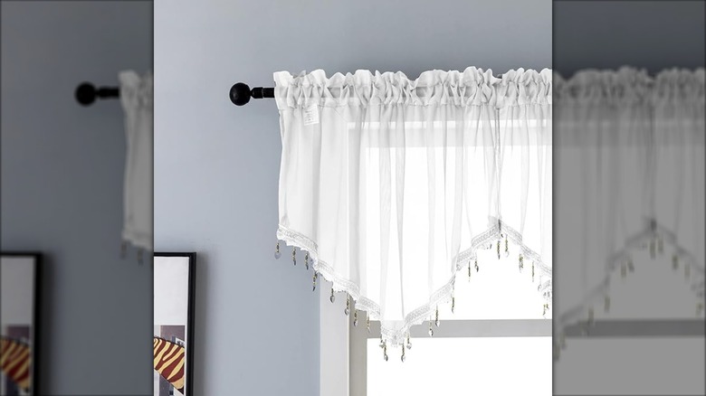 Decorative beaded valance hanging over a window