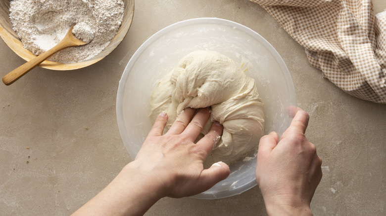kneading dough in bowl