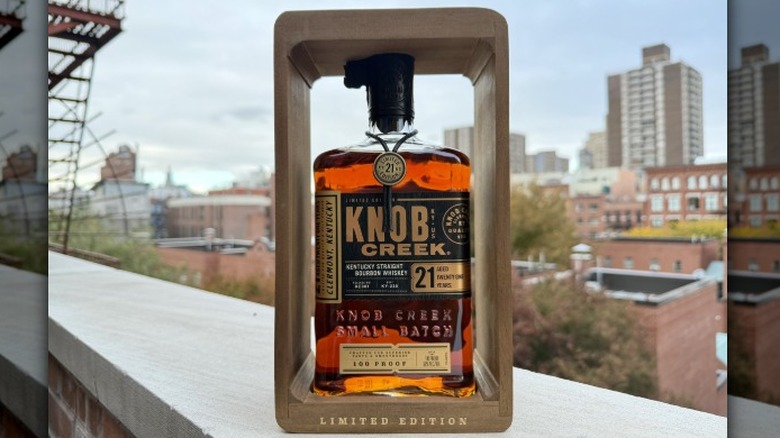 A bottle of the Knob Creek 21 Year bourbon on a rooftop