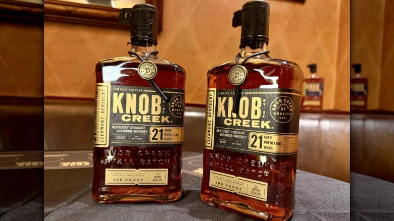 Two bottles of Knob Creek 21 Year bourbon on a table