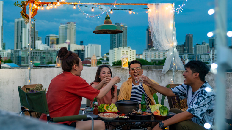 group of friends cheers with soju