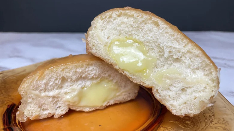 a Krispy Kreme lemon filled donut cut open to show the insides