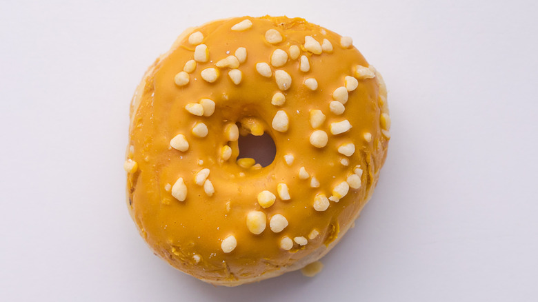 Close up of doughnut with grains on white background