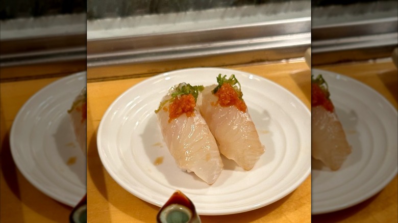 White fish sushi from Hama Sushi on a white saucer