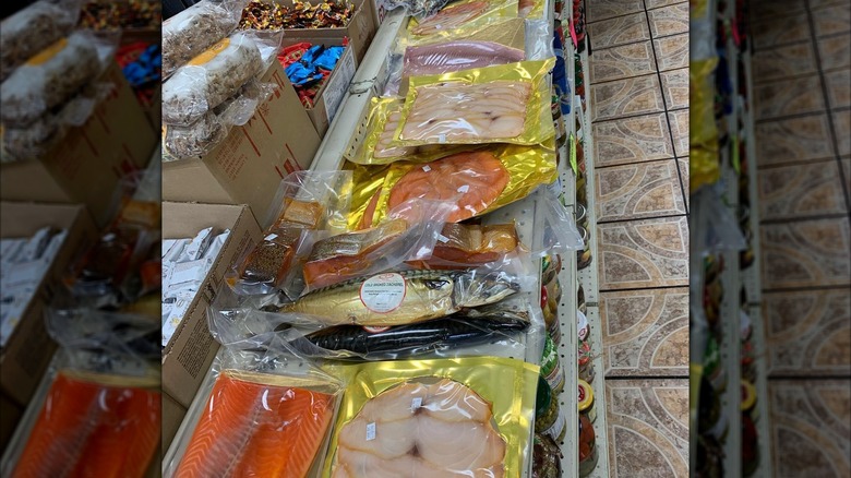 Smoked, vacuum sealed fish stacked on display