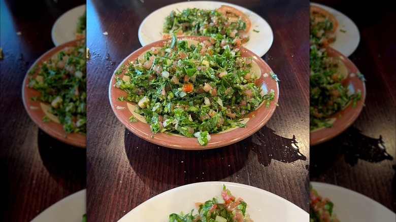 Bowls of tabouli on wooden table