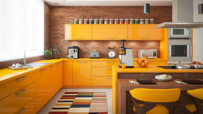 View of kitchen with yellow lacquered cabinets
