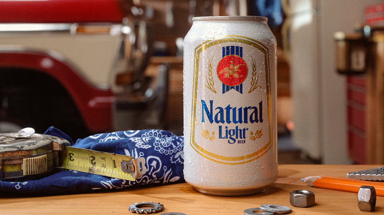 A can of Natural Light shown on a workbench surrounded by fixtures and fittings