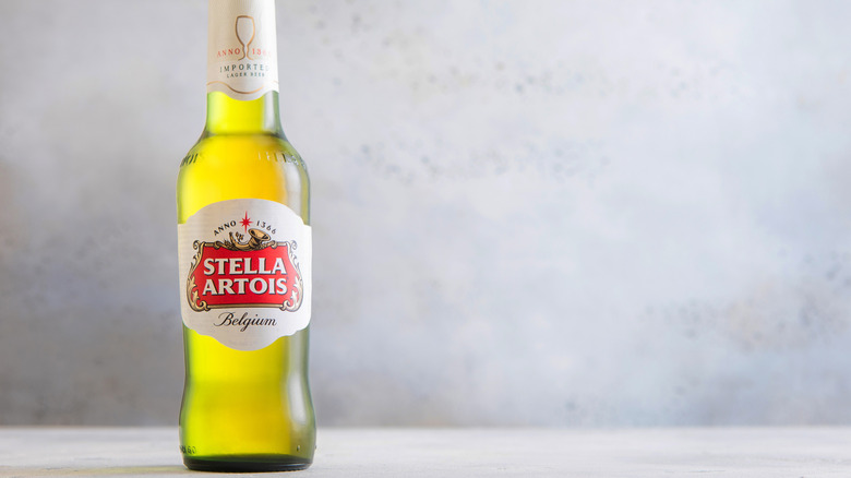 A single bottle of Stella Artois posed on a plain background