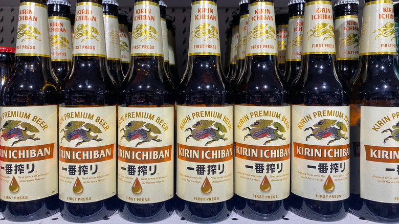 A close shot of a shelf packed tightly with bottles of Kirin Ichiban