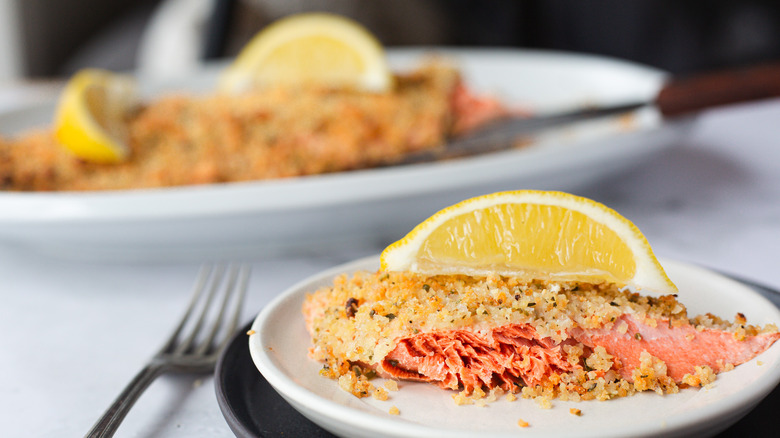 Side view of salmon with parmesan crust and fork