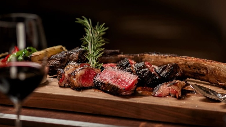 Platter of steak and wine glass at CUT Las Vegas