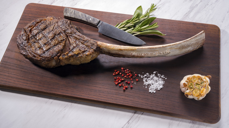 Carversteak tomahawk on cutting board with rosemary