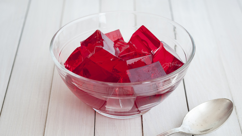 Red Jell-O cubes in a glass bowl