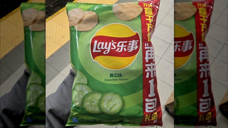 Bag of cucumber Lay's potato chips from China with train platform in the background