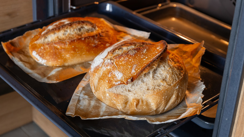 freshly baked homemade bread pulled out of oven