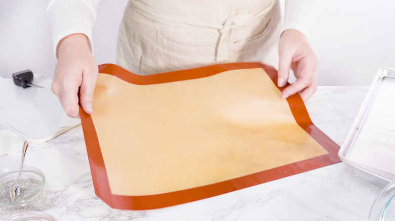 chef holding silicone baking mat