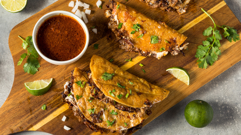 Birria tacos on a chopping board