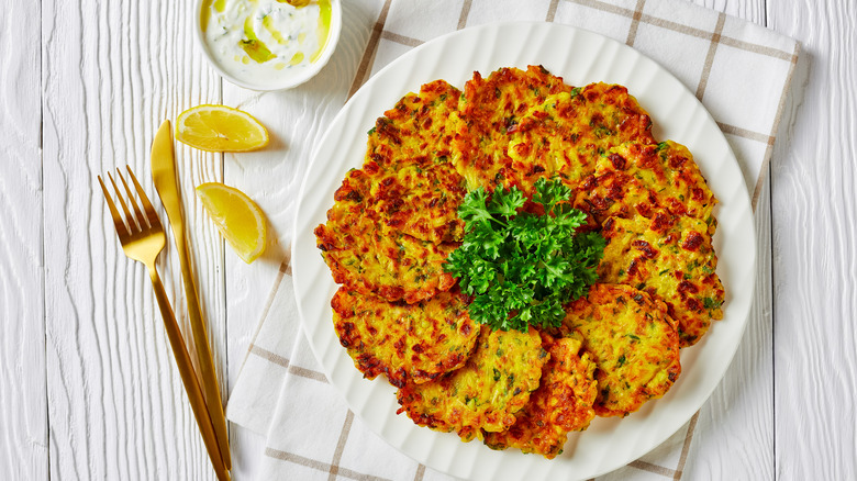 crispy fritters topped with green parsley and lemon slices