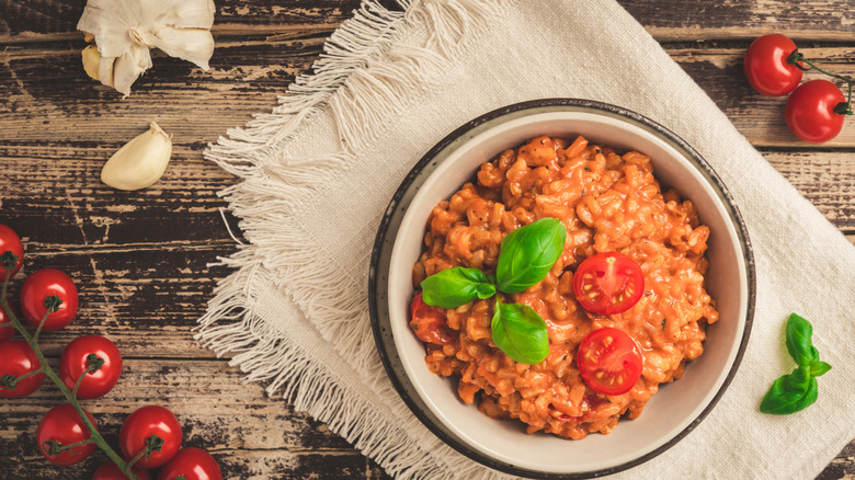 red tomato risotto on a rustic wood table