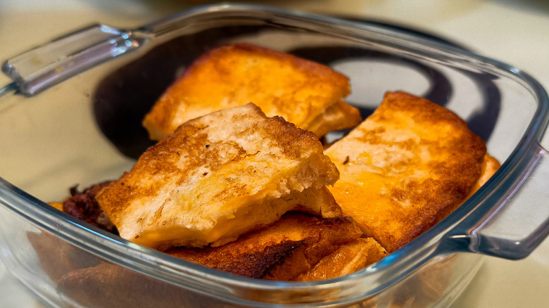 Mini grilled cheese sandwiches in a clear dish