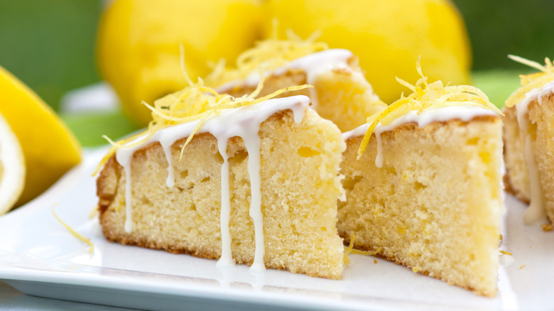slices of lemon cake with frosting and lime zest