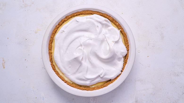 adding meringue to lemon pie