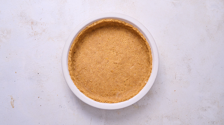 pressing pie crust into pie pan