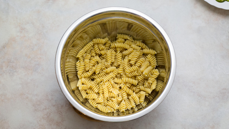 drained pasta in mixing bowl