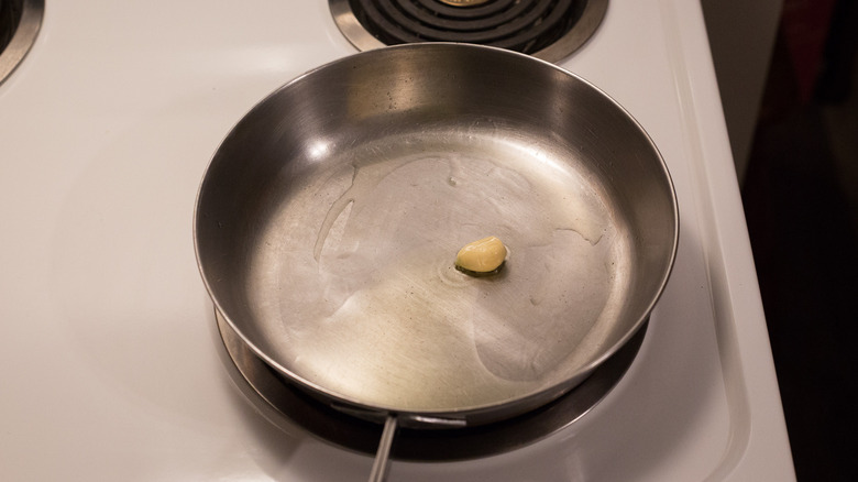 garlic cooking in metal pan