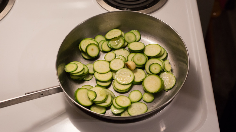 zucchini slices cooking in pan