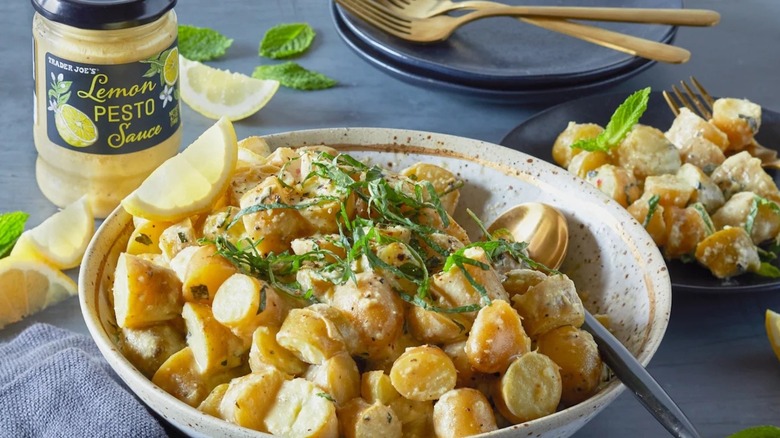 A jar of Trader Joe's Lemon Pesto Sauce next to a bowl of potatoes