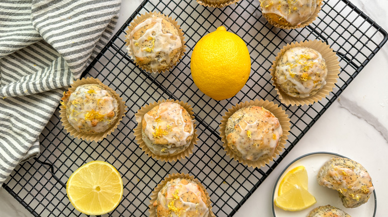 iced lemon poppy seed muffins on cooling rack