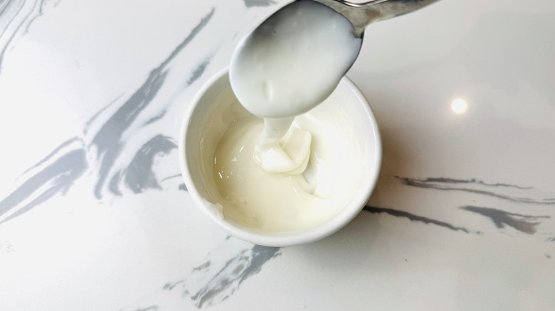 Spoon drizzling glaze in bowl