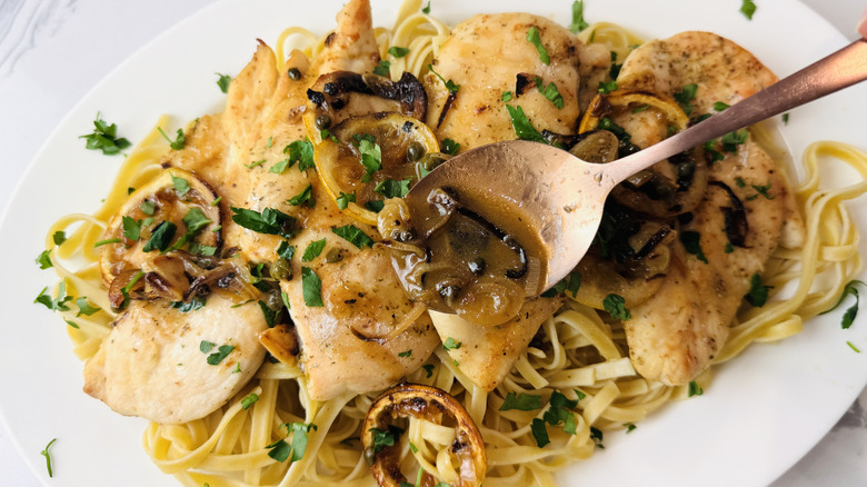 Chicken piccata on serving platter with sauce