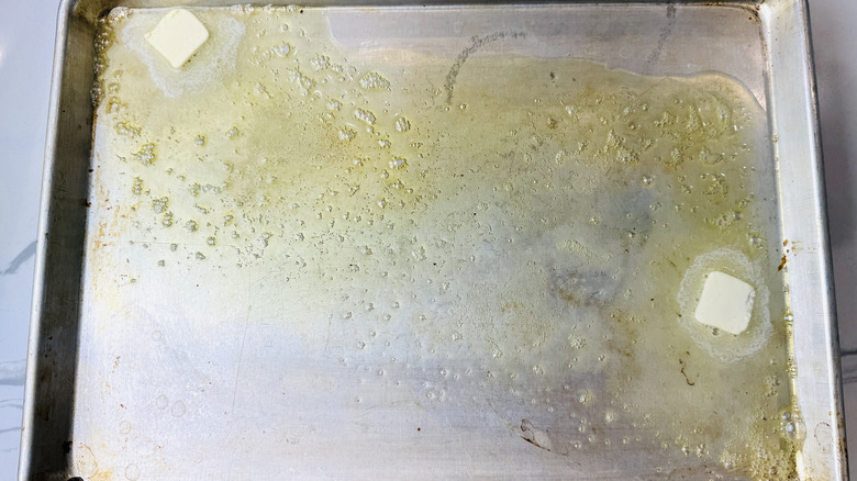 Butter melting on hot baking sheet