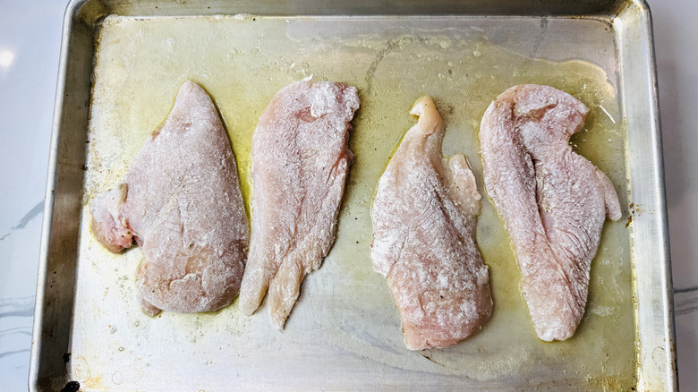 Dredged chicken on baking sheet