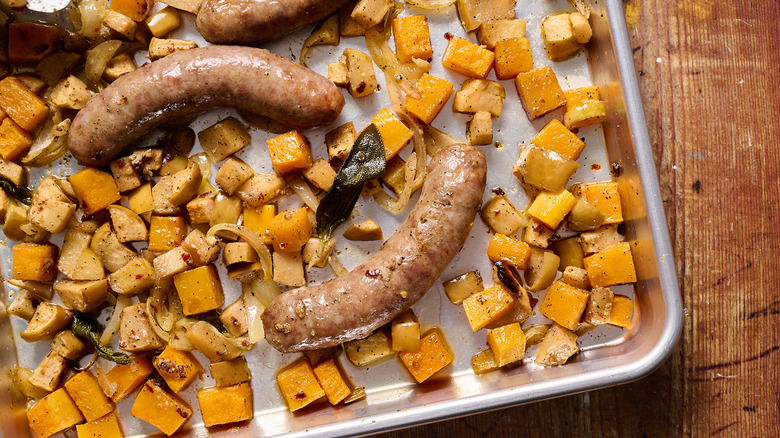 Roasted sausages with chunks of squash and apples