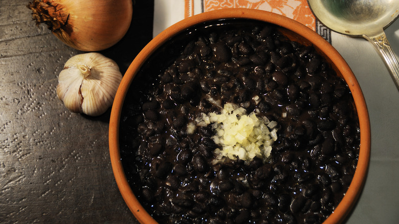 a bowl of black beans with garnish