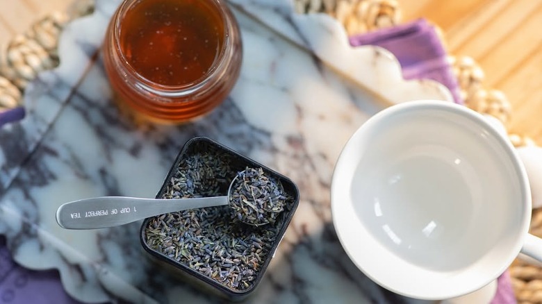 Dried lavender, honey, and a cup