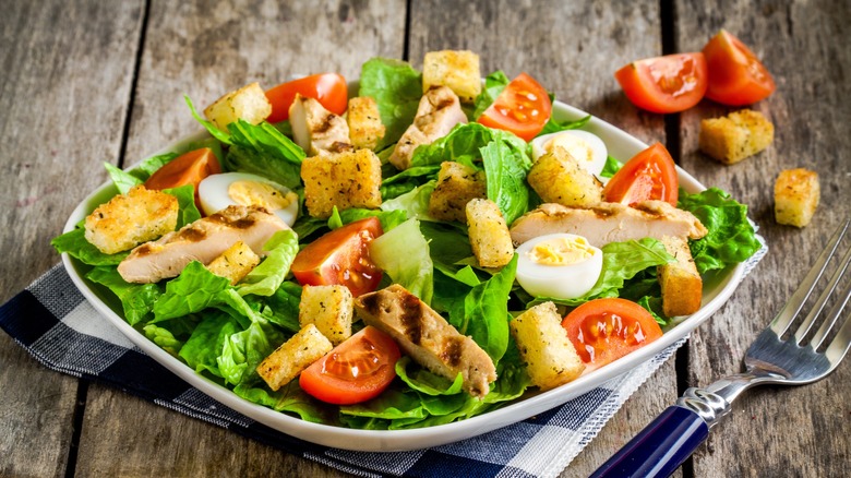 Lettuce, tomato, egg, and chicken salad with croutons