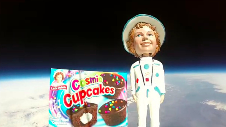 The box of Little Debbie Cosmic Cupcakes and bobblehead in space as shot by the Go Pro attached to the balloon