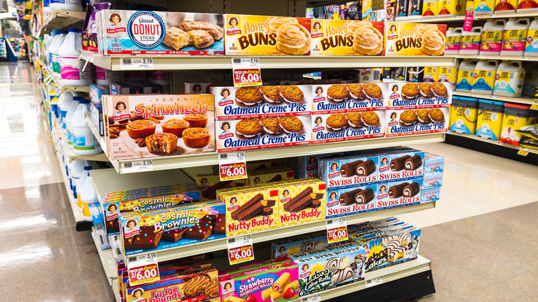 Shelves of Little Debbie snack cakes in supermarket aisle