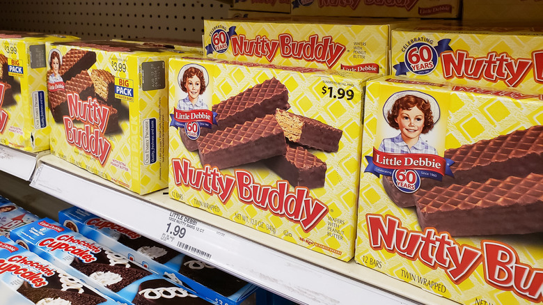 Several boxes of Little Debbie Nutty Buddy wafer bars stacked on a store shelf