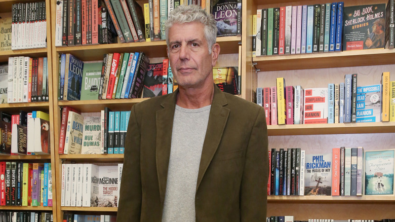 Anthony Bourdain standing in a bookstore