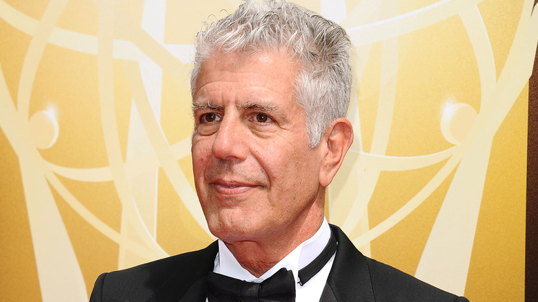 Anthony Bourdain in a tux, posing at a red-carpet event