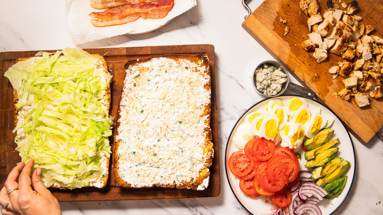 Layering focaccia with lettuce