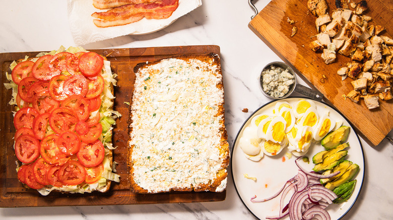 Layering focaccia with tomatoes